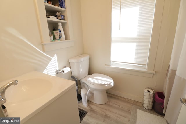 bathroom featuring hardwood / wood-style floors and toilet