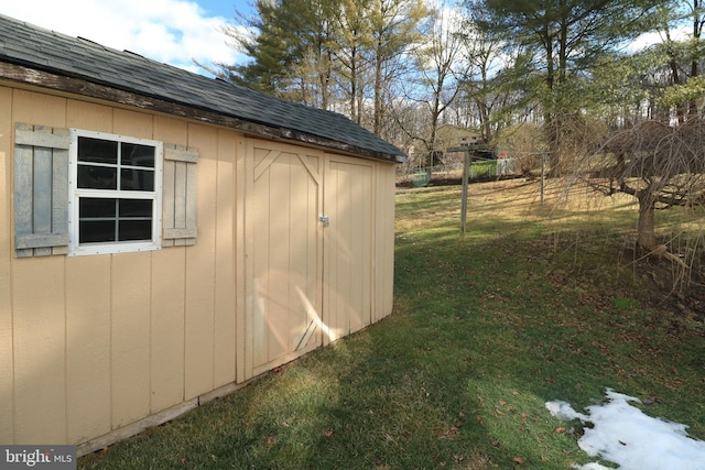 view of outbuilding featuring a yard