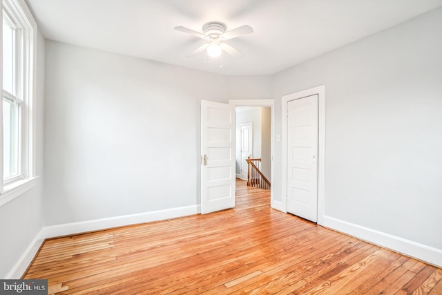 spare room featuring ceiling fan and light hardwood / wood-style floors