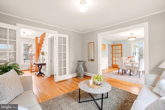 living room featuring crown molding, hardwood / wood-style floors, and french doors