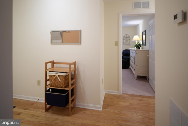 hall with light hardwood / wood-style floors