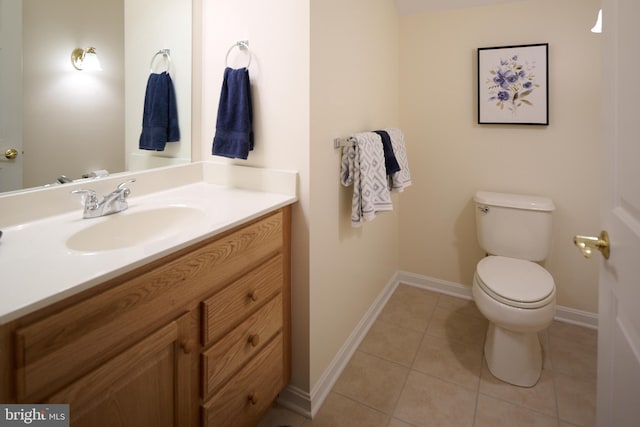 bathroom featuring vanity, tile patterned floors, and toilet