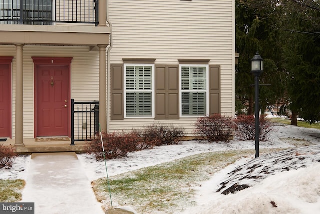 view of snow covered property entrance