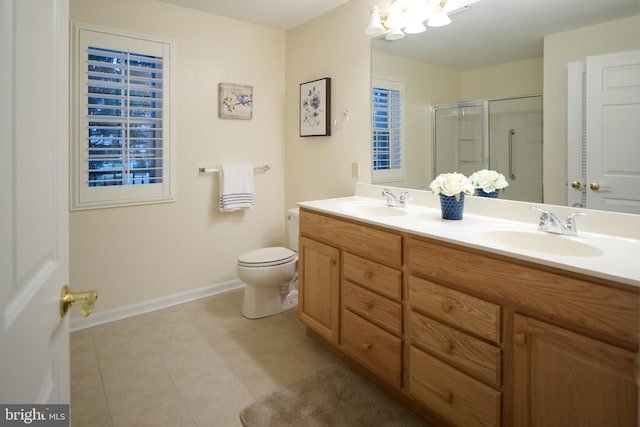 bathroom featuring tile patterned flooring, vanity, toilet, and walk in shower