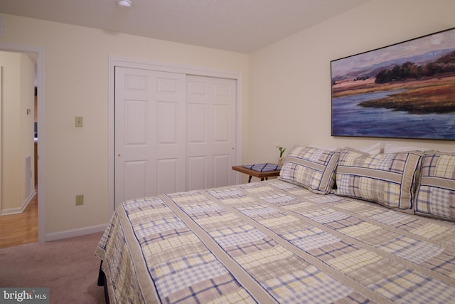 unfurnished bedroom featuring light carpet and a closet