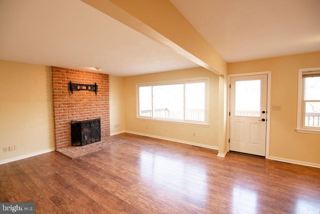 unfurnished living room with wood-type flooring and a fireplace