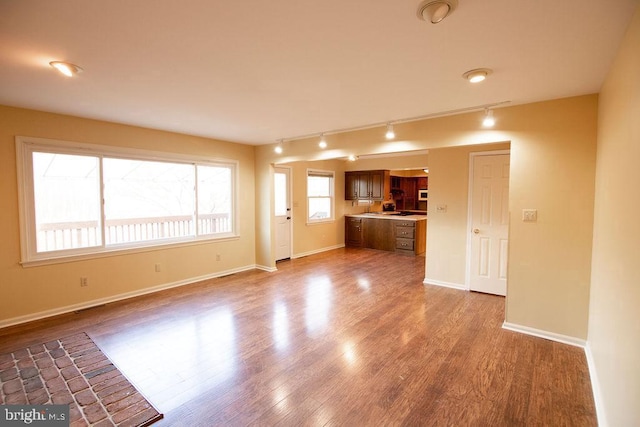 unfurnished living room with dark hardwood / wood-style flooring