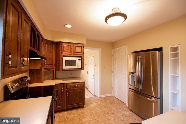 kitchen featuring stainless steel appliances and light tile patterned floors