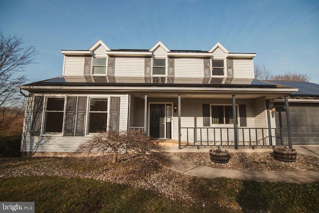 view of front of house with a porch and a garage