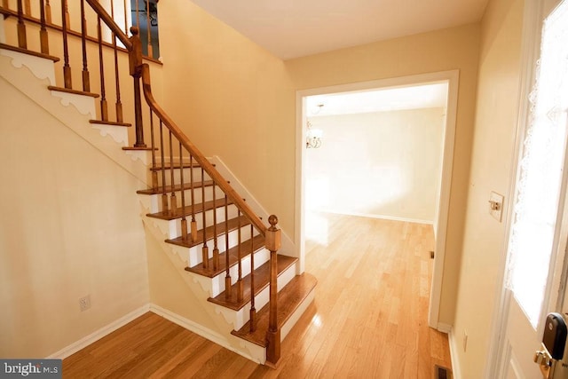 stairs featuring hardwood / wood-style flooring