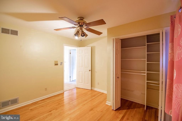 unfurnished bedroom with a closet, ceiling fan, and light wood-type flooring