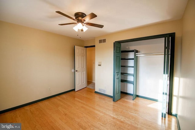 unfurnished bedroom with ceiling fan, a closet, and light wood-type flooring