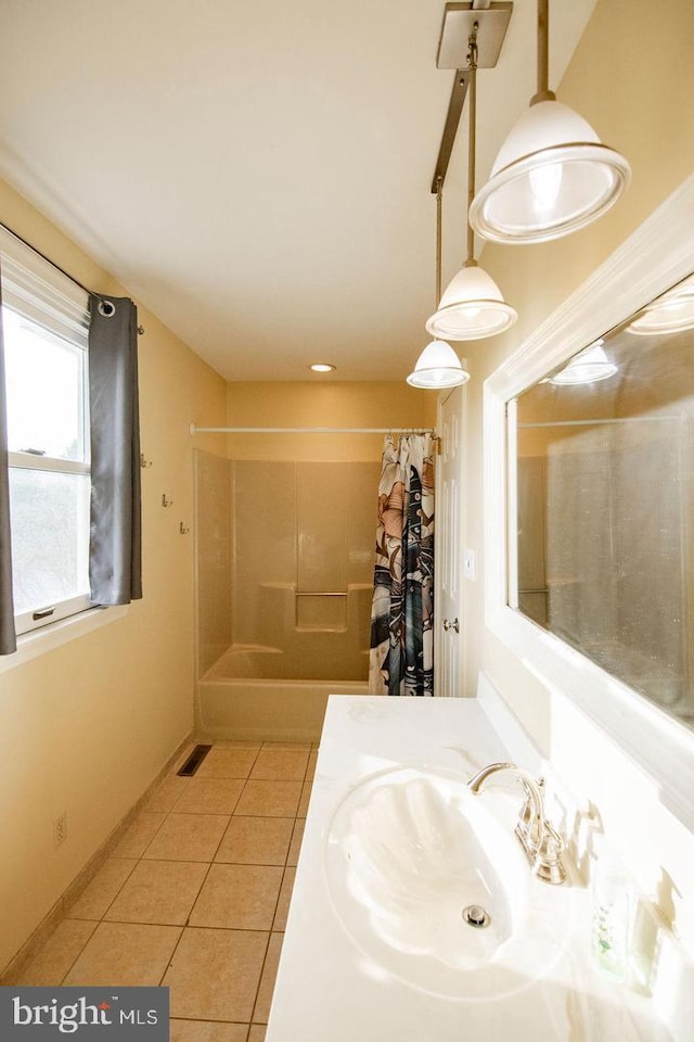 bathroom with vanity, shower / bathtub combination with curtain, and tile patterned floors