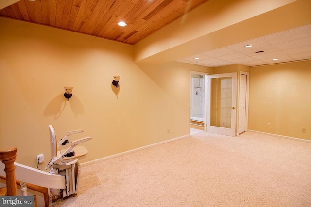 interior space with carpet floors and wood ceiling