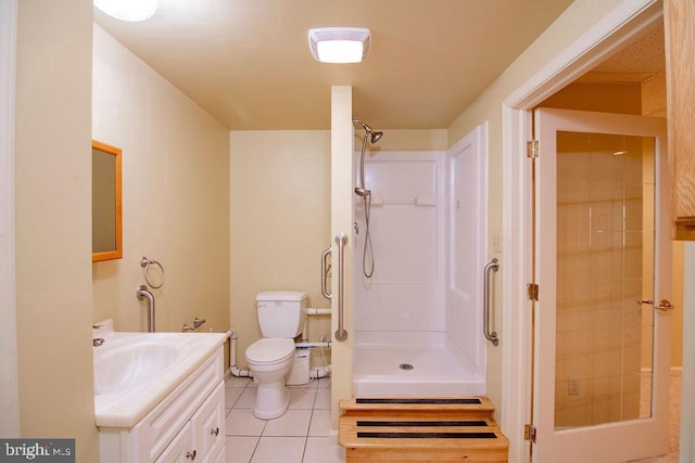 bathroom featuring vanity, tile patterned floors, toilet, and walk in shower