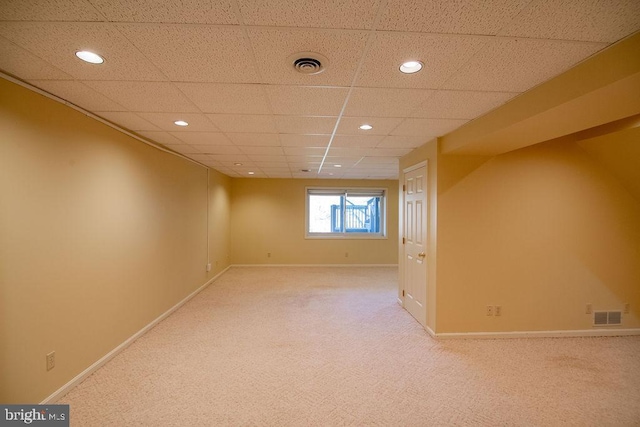 basement with light carpet and a drop ceiling