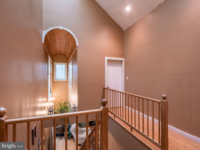 corridor featuring lofted ceiling and light hardwood / wood-style flooring