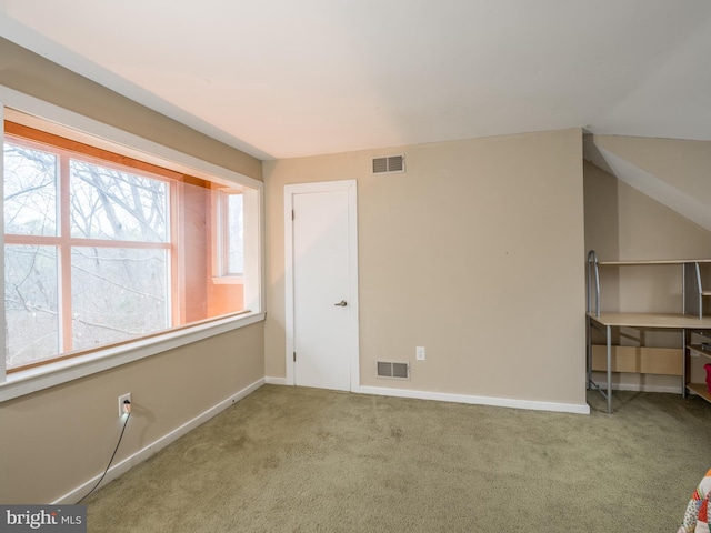 spare room featuring light carpet