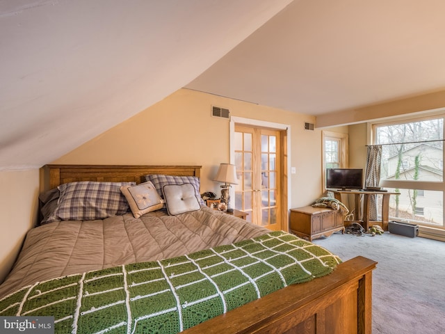 bedroom featuring vaulted ceiling, carpet floors, and french doors