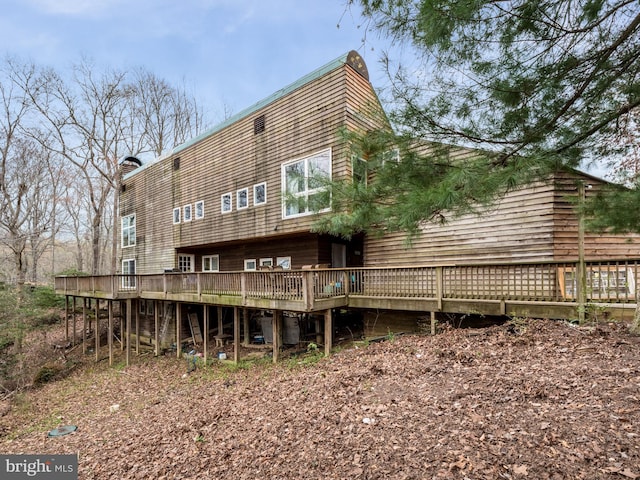 rear view of property featuring a deck