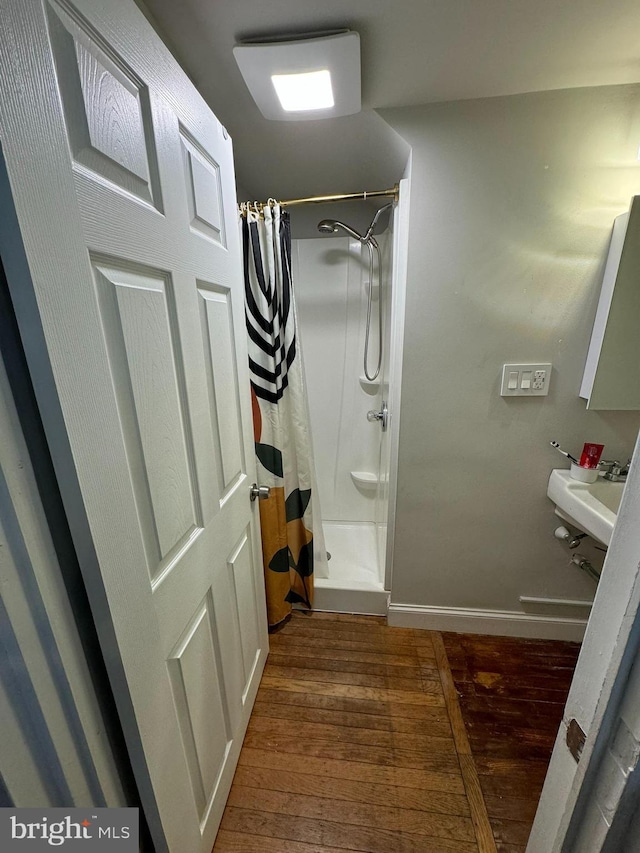 bathroom featuring hardwood / wood-style floors and curtained shower