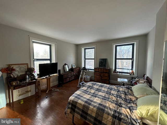 bedroom with dark hardwood / wood-style floors