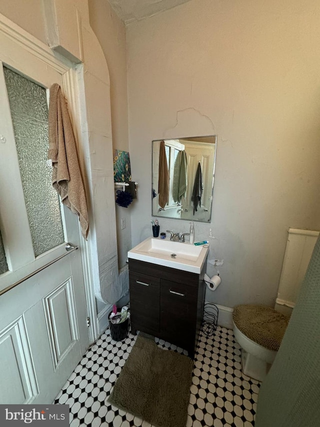 bathroom featuring vanity and toilet