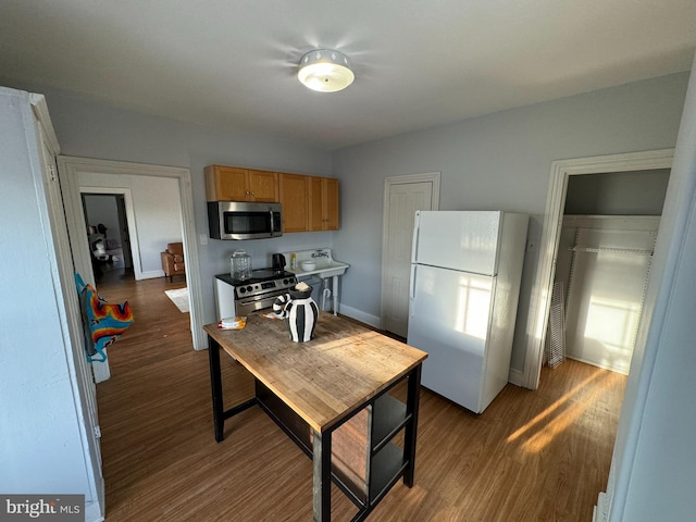 kitchen with dark wood-type flooring and stainless steel appliances