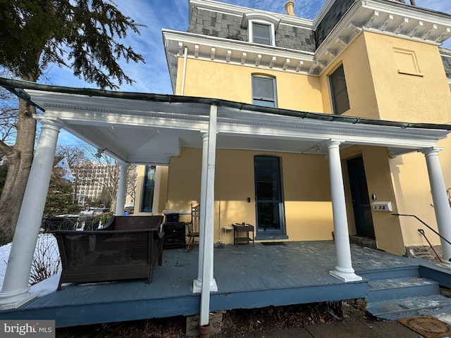 back of house featuring a deck