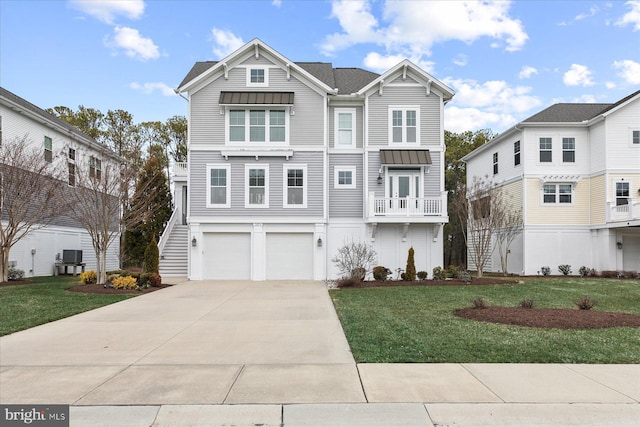 view of front of home featuring stairs, a garage, concrete driveway, and a front yard