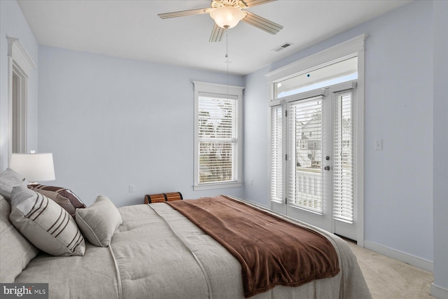 carpeted bedroom featuring access to exterior, a ceiling fan, and baseboards