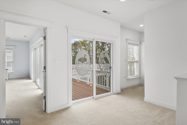 doorway to outside with recessed lighting, visible vents, baseboards, and carpet