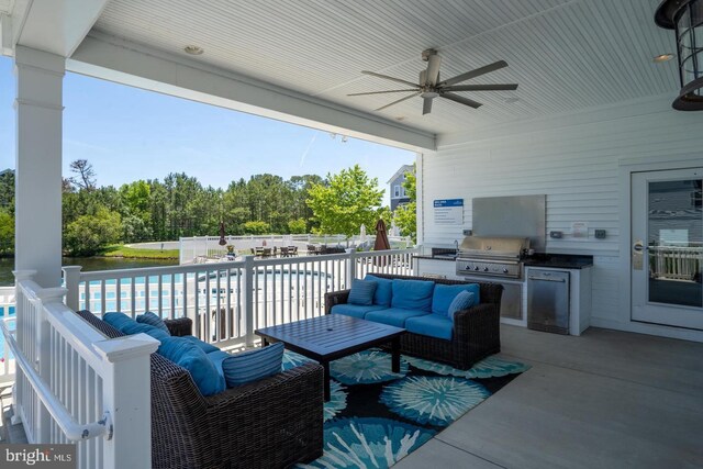 view of patio with an outdoor living space, a fenced in pool, ceiling fan, area for grilling, and an outdoor kitchen