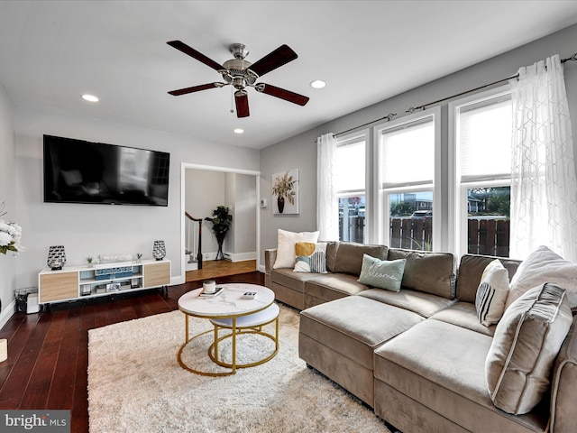 living room with dark wood-type flooring and ceiling fan