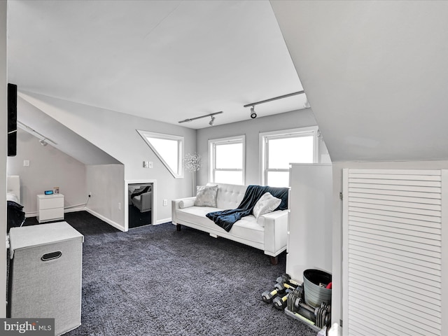 living room with vaulted ceiling, rail lighting, and dark carpet