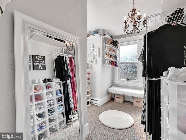 walk in closet featuring an inviting chandelier and carpet