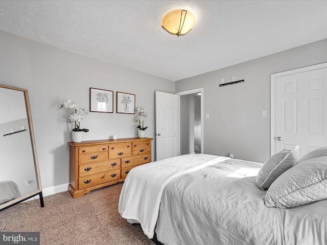 bedroom featuring light colored carpet and a textured ceiling