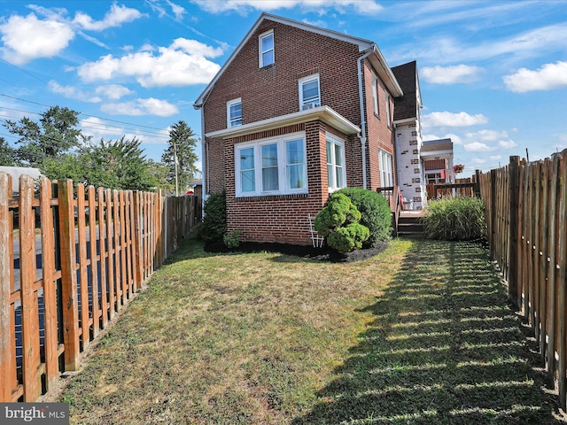 view of home's exterior with a yard