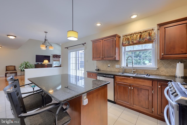 kitchen with a wealth of natural light, dishwasher, gas range, a breakfast bar, and a sink