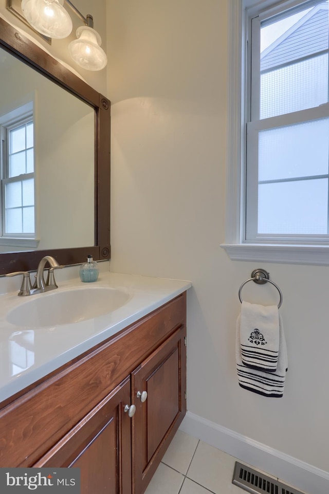 bathroom featuring tile patterned flooring, a wealth of natural light, and vanity