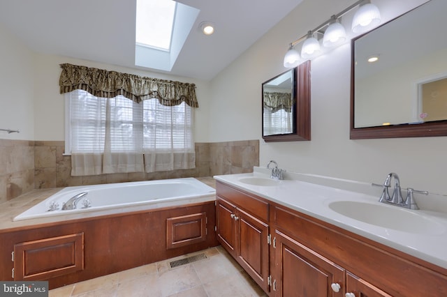 full bath with a garden tub, a sink, visible vents, and double vanity