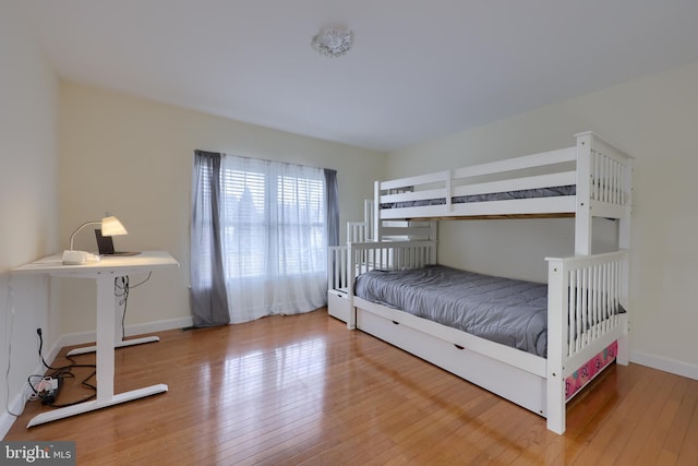 unfurnished bedroom featuring baseboards and hardwood / wood-style flooring