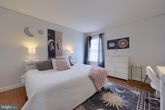 bedroom featuring baseboards and wood finished floors