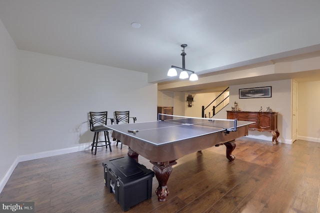 recreation room with baseboards and dark wood finished floors