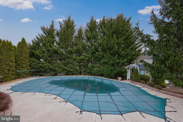 view of swimming pool with a covered pool and a patio