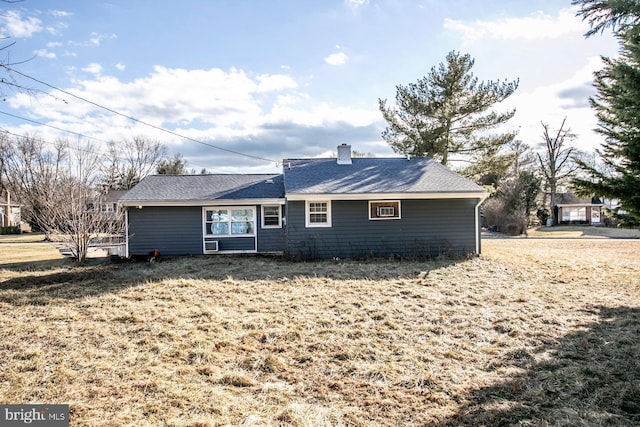 rear view of property with a yard