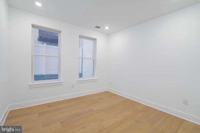 unfurnished room with light hardwood / wood-style floors