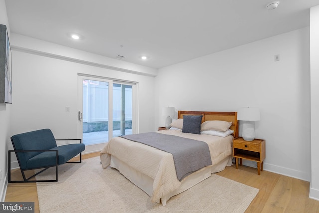 bedroom featuring access to outside and light hardwood / wood-style floors