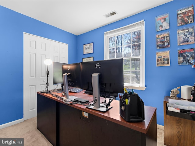 office space with baseboards, visible vents, and light colored carpet