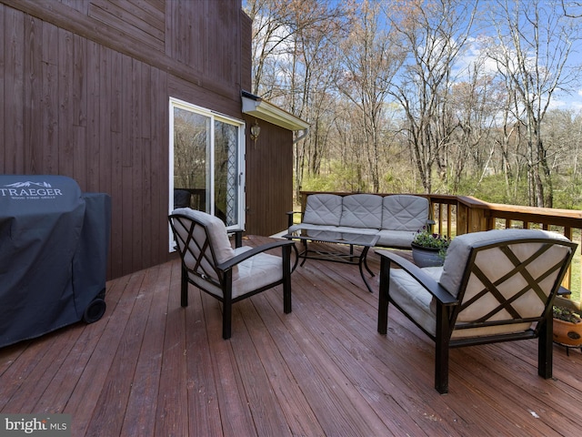 wooden deck featuring grilling area and an outdoor hangout area